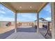 Covered deck offers a comfortable outdoor living space with views of the extensive yard at 16360 Paris Way, Brighton, CO 80602