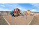 A beautiful playground with a slide and swing set surrounded by a white fence at 16360 Paris Way, Brighton, CO 80602