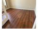 The room features wood floors and neutral wall paint, door entrance, and natural lighting at 16360 Paris Way, Brighton, CO 80602
