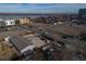 An aerial view of the property highlights its location with access to the street and nearby lake at 1571 Sheridan Blvd, Lakewood, CO 80214