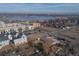 Stunning aerial view of the neighborhood with the buildings, street, and lake creating a picturesque scene at 1571 Sheridan Blvd, Lakewood, CO 80214