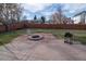 Backyard with stone patio, fire pit, and grill at 1571 Sheridan Blvd, Lakewood, CO 80214