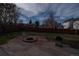 Backyard with stone patio, fire pit, and grill at 1571 Sheridan Blvd, Lakewood, CO 80214
