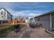 Backyard with patio, grill, outdoor dining, and adjacent playset and RV parking at 1571 Sheridan Blvd, Lakewood, CO 80214