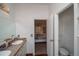 Bathroom with double vanity and access to bedroom at 1571 Sheridan Blvd, Lakewood, CO 80214