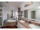 Spacious bathroom featuring a large soaking tub, dual sinks and decorative lighting at 1571 Sheridan Blvd, Lakewood, CO 80214