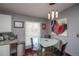 Cozy dining area adjacent to kitchen with modern lighting and artwork at 1571 Sheridan Blvd, Lakewood, CO 80214