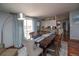 Dining area features hardwood floors, backyard access, and view to the kitchen at 1571 Sheridan Blvd, Lakewood, CO 80214