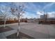 Front yard with driveway and street view at 1571 Sheridan Blvd, Lakewood, CO 80214