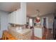 Kitchen with granite countertops, mosaic backsplash, an island, and modern appliances at 1571 Sheridan Blvd, Lakewood, CO 80214