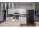 Kitchen with granite countertops, stainless steel appliances, and an island with breakfast bar at 1571 Sheridan Blvd, Lakewood, CO 80214