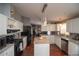 Well-lit kitchen featuring granite countertops, stainless steel appliances, and an island at 1571 Sheridan Blvd, Lakewood, CO 80214