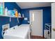 Bright laundry room, washer, dryer, and storage shelves at 1571 Sheridan Blvd, Lakewood, CO 80214