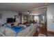 Open concept living and dining area with hardwood floors and ample natural light at 1571 Sheridan Blvd, Lakewood, CO 80214