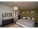 Cozy main bedroom featuring a comfortable bed, decorative lighting and accent wall at 1571 Sheridan Blvd, Lakewood, CO 80214
