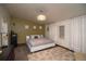 Cozy main bedroom featuring a comfortable bed, decorative lighting and accent wall at 1571 Sheridan Blvd, Lakewood, CO 80214