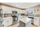 Modern kitchen featuring stainless steel appliances, white cabinets, and a center island at 3166 W Indian Summer Ln, Castle Rock, CO 80109