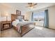 Bright main bedroom featuring a large bed, side tables, and window with view at 3166 W Indian Summer Ln, Castle Rock, CO 80109
