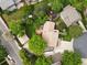 Aerial view of a home with a large backyard, mature trees, and a detached garage at 5860 W Atlantic Dr, Lakewood, CO 80227