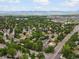 Breathtaking aerial view of a lush residential neighborhood with tree-lined streets and mountain views at 5860 W Atlantic Dr, Lakewood, CO 80227