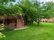 Backyard with steps up to a deck and a well manicured lawn and garden at 5860 W Atlantic Dr, Lakewood, CO 80227