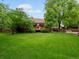 Spacious and well maintained backyard with deck, mature trees, and lawn at 5860 W Atlantic Dr, Lakewood, CO 80227