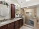 Bathroom with double vanity, a glass shower, and a skylight at 5860 W Atlantic Dr, Lakewood, CO 80227