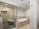 Luxurious bathroom with large soaking tub and walk-in glass shower at 5860 W Atlantic Dr, Lakewood, CO 80227