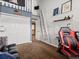 Cozy bedroom space with a ladder, closet, and a comfortable red and black gaming chair at 5860 W Atlantic Dr, Lakewood, CO 80227