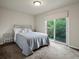 Bedroom with gray carpet and a glass sliding door to the yard at 5860 W Atlantic Dr, Lakewood, CO 80227