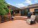 Lovely backyard deck with an arbor, outdoor furniture, and access to the house at 5860 W Atlantic Dr, Lakewood, CO 80227