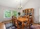 Bright dining room with a large window, classic wood furniture and hardwood flooring at 5860 W Atlantic Dr, Lakewood, CO 80227