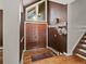 Welcoming foyer with hardwood floors, a decorative double-door entrance, and coat hooks near the staircase at 5860 W Atlantic Dr, Lakewood, CO 80227