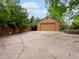 Detached two car garage with a large parking area and a wooden fence at 5860 W Atlantic Dr, Lakewood, CO 80227