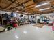 Spacious garage with ample storage, a gym, tools, and a ceiling fan at 5860 W Atlantic Dr, Lakewood, CO 80227