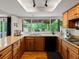 Well-lit kitchen with updated countertops, cabinetry, stainless appliances and hardwood flooring at 5860 W Atlantic Dr, Lakewood, CO 80227