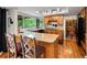 Bright kitchen featuring granite counters, stainless appliances, hardwood flooring, and seating at the bar at 5860 W Atlantic Dr, Lakewood, CO 80227