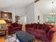 Spacious living room with vaulted ceilings, hardwood floors, and comfortable seating with bright natural light at 5860 W Atlantic Dr, Lakewood, CO 80227