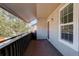 Balcony with gray walls and brown flooring, showing the door, large window, and metal railing at 7165 S Gaylord St # E09, Centennial, CO 80122