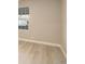 Bright, empty bedroom featuring a window and wood-look flooring at 7165 S Gaylord St # E09, Centennial, CO 80122
