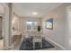 Bright dining room features a dining table with seating for six and a view of the kitchen at 7165 S Gaylord St # E09, Centennial, CO 80122