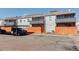 Apartment building exterior with parking spaces, carports, balconies, and a clean facade at 7165 S Gaylord St # E09, Centennial, CO 80122