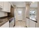 Bright kitchen featuring stainless steel appliances, white cabinets, and a door leading to the exterior at 7165 S Gaylord St # E09, Centennial, CO 80122