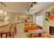 Inviting living room with fireplace, bright window, and breakfast bar to the kitchen at 7165 S Gaylord St # E09, Centennial, CO 80122