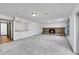 Basement featuring a stone fireplace, a cozy bar, and carpet flooring, perfect for relaxing and entertaining at 3792 S Fenton Way, Denver, CO 80235