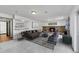 Staged basement showcasing a cozy seating area with a stone fireplace, plus a bar for entertaining guests at 3792 S Fenton Way, Denver, CO 80235