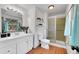 Bathroom featuring a white vanity with modern fixtures, alongside a glass-enclosed shower with tile surround at 3792 S Fenton Way, Denver, CO 80235
