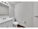 The bathroom features a single sink vanity, a standard toilet, and mirrored wall at 3792 S Fenton Way, Denver, CO 80235