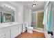 Bathroom featuring a white vanity with modern fixtures, alongside a glass-enclosed shower with tile surround at 3792 S Fenton Way, Denver, CO 80235