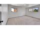 A bright, airy bedroom featuring two windows for plenty of natural light and neutral carpeting throughout at 3792 S Fenton Way, Denver, CO 80235